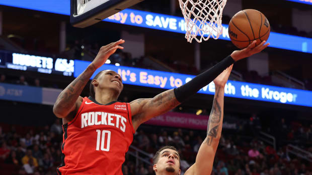 Rockets forward Jabari Smith Jr. (10) scores against Denver Nuggets forward Michael Porter Jr. (1) in the second quarter at Toyota Center.